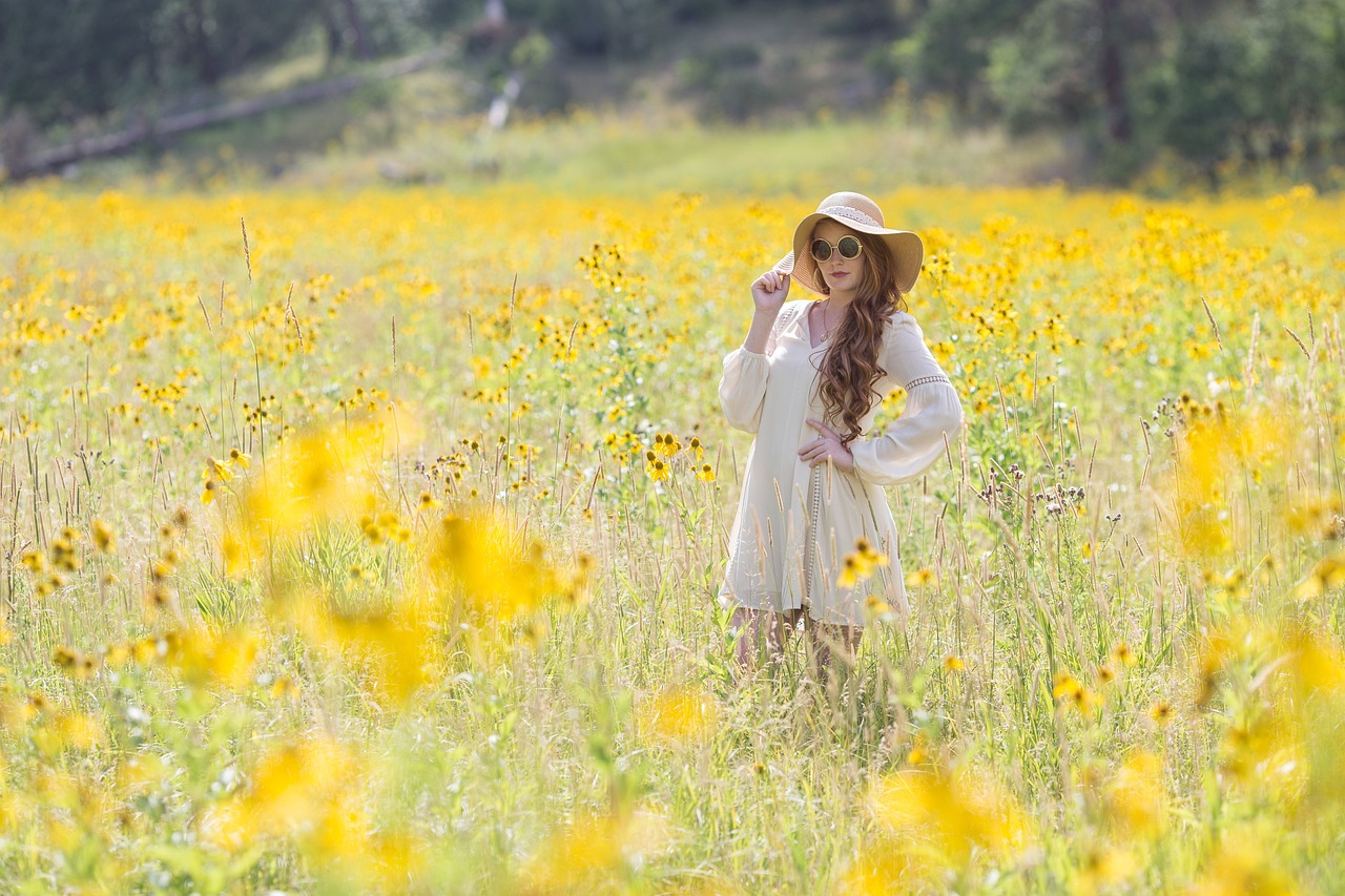 Redhead woman in a sunny wildflower field, her skin protected by mineral sunscreen safe for pregnancy.