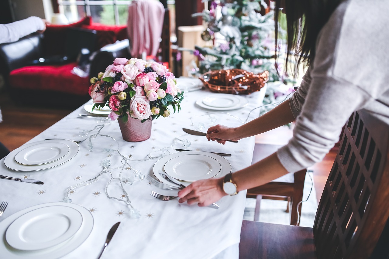 A festive table set with dishes and flowers, ready for a meal, reflecting smart pregnancy food safety choices.