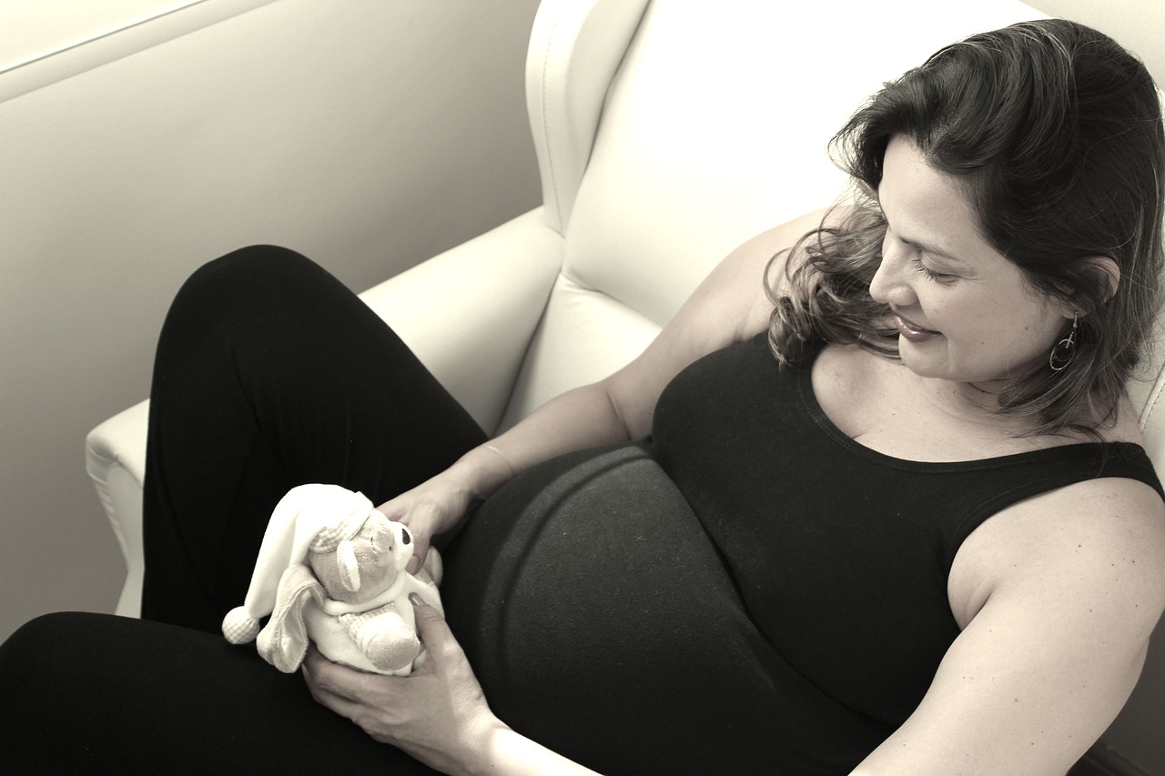 A radiant pregnant woman with glowing skin, demonstrating the power of essential skincare ingredients.