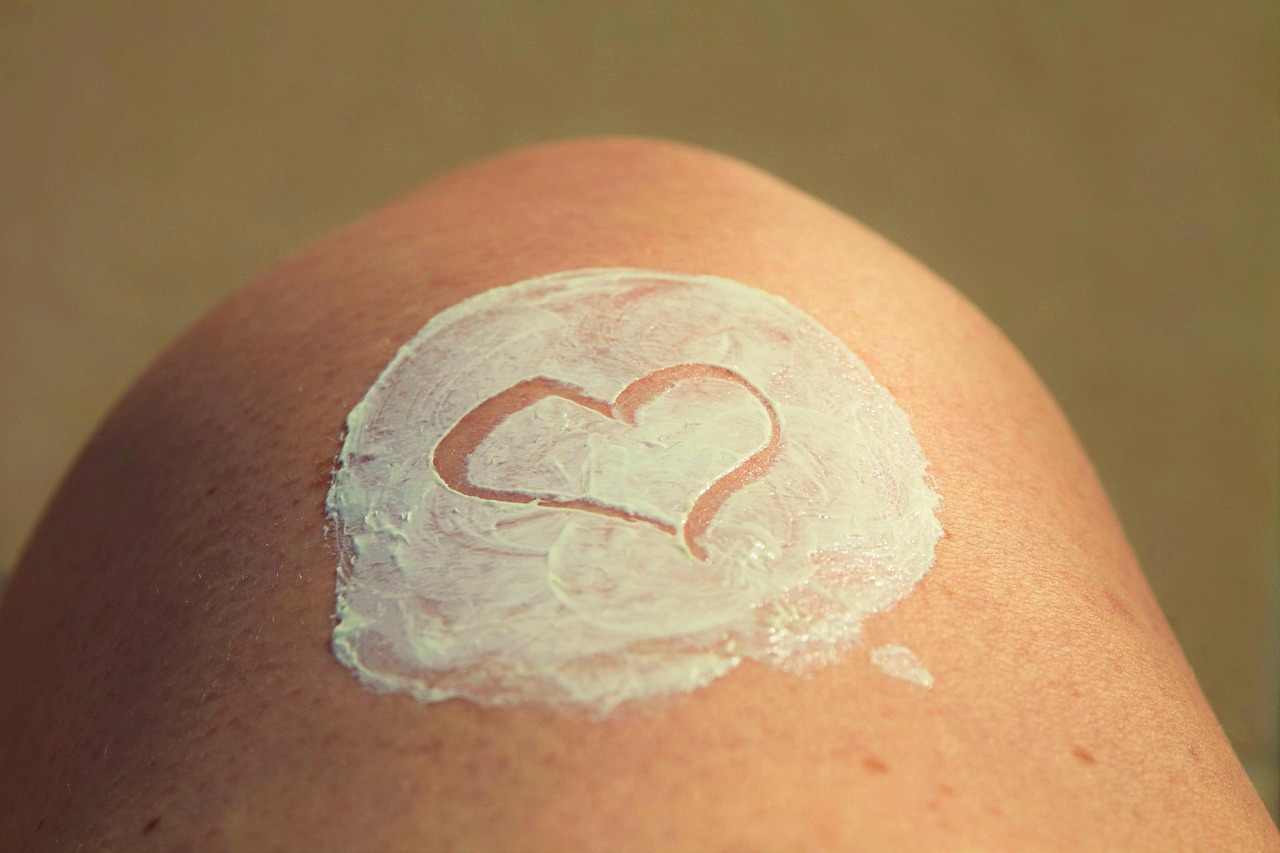 Brown skin with a heart drawn in mineral sunscreen, for pregnancy-safe protection.