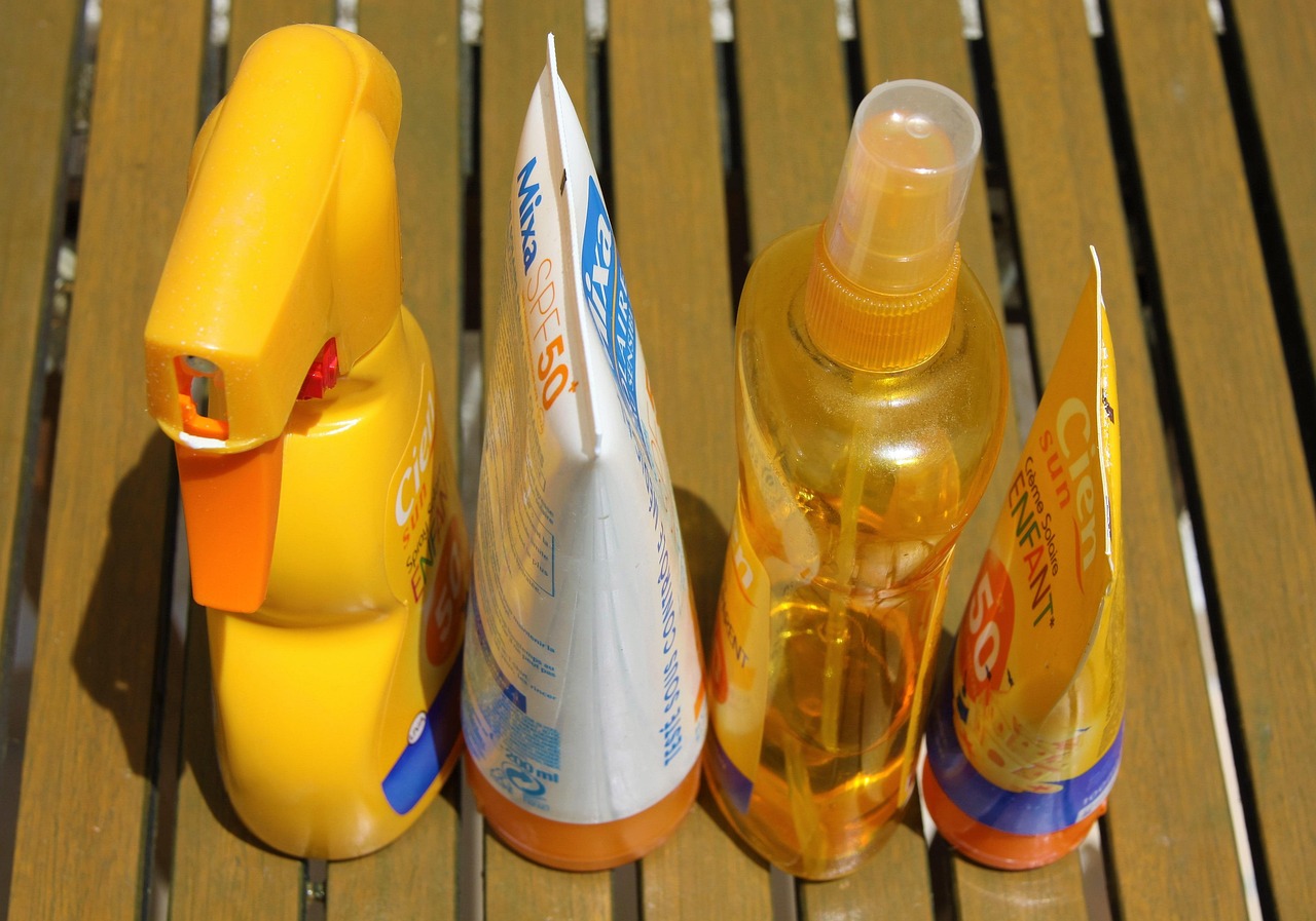 Brown bottle of mineral zinc oxide sunscreen applied to skin, for safe pregnancy sun protection.