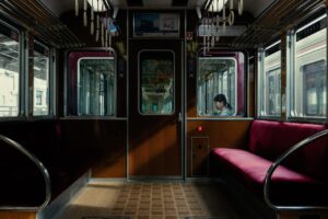 A woman waits for a morning train in Kyoto, Japan, considering pregnancy-safe natural skincare.