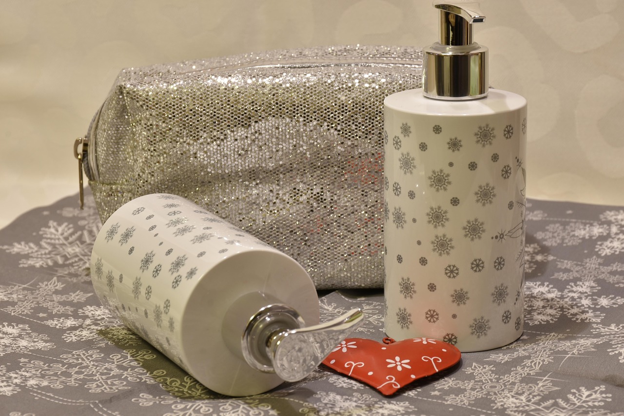 White pump bottle and cylindrical containers with patterned wrap on a table, comparing pregnancy-safe skincare products