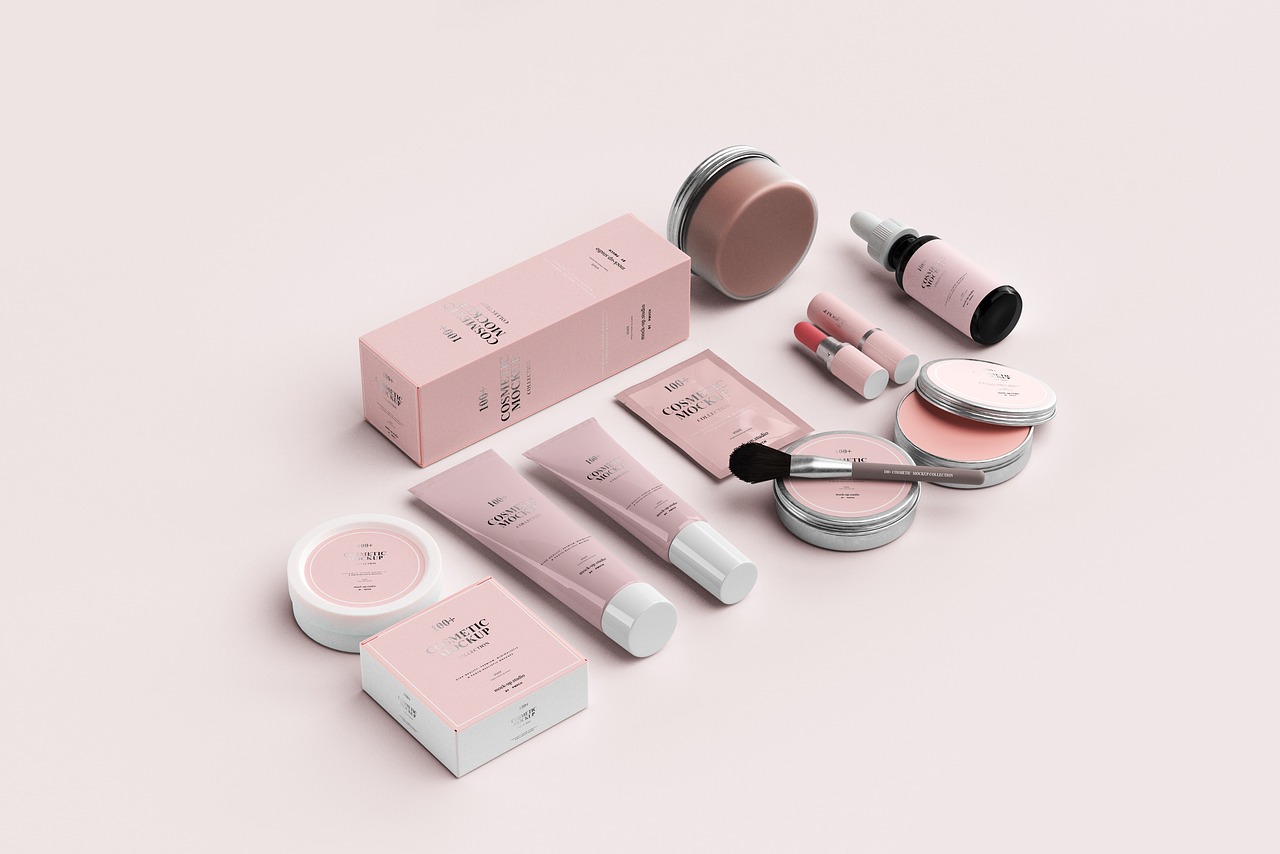 Pink skincare tubes, jars and dropper bottle arranged on a blush surface, representing comparing skincare brands
