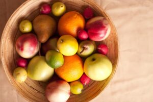 Wicker basket of apples, pears, oranges and lemons, representing choosing safe nutritious food
