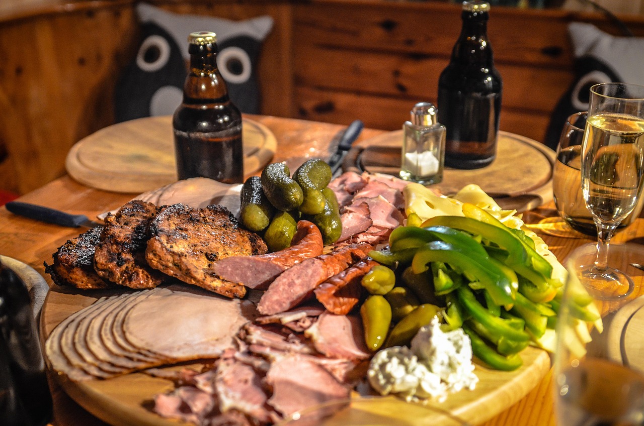 Charcuterie board with deli meats, pickles and cheese, representing foods to be careful with for listeria in pregnancy