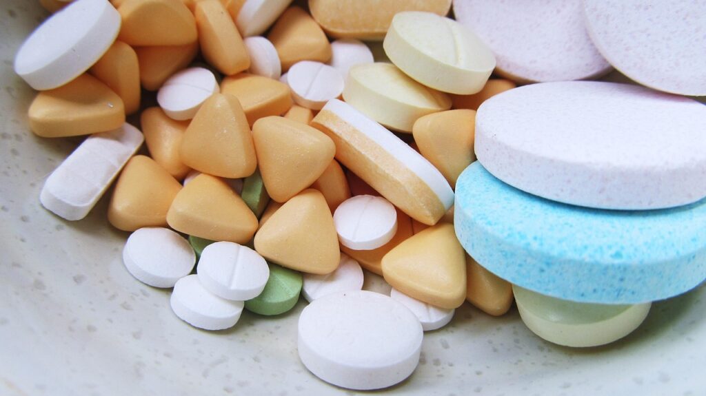 Assorted colorful tablets and pills close up, illustrating loratadine allergy medication safety in pregnancy