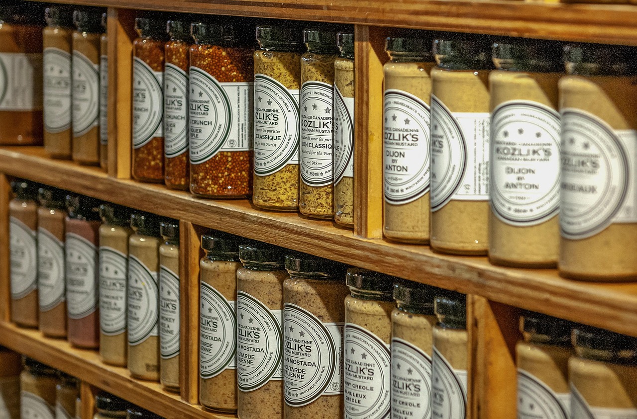 Shelves of labeled glass jars of sauces and condiments, representing checking ingredient labels