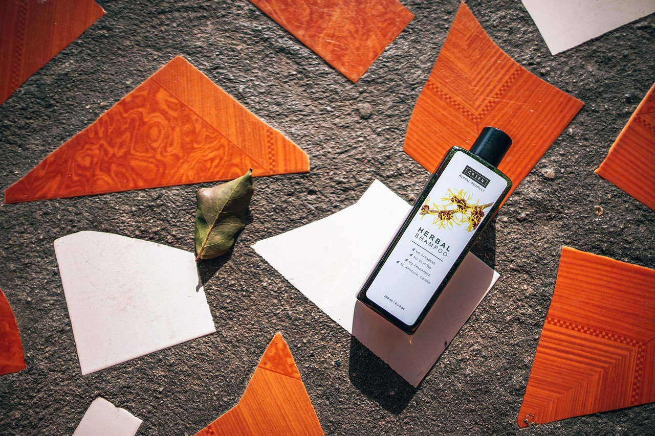 Bottle of herbal shampoo lying on orange tiles and paper, representing pregnancy-safe hair care products