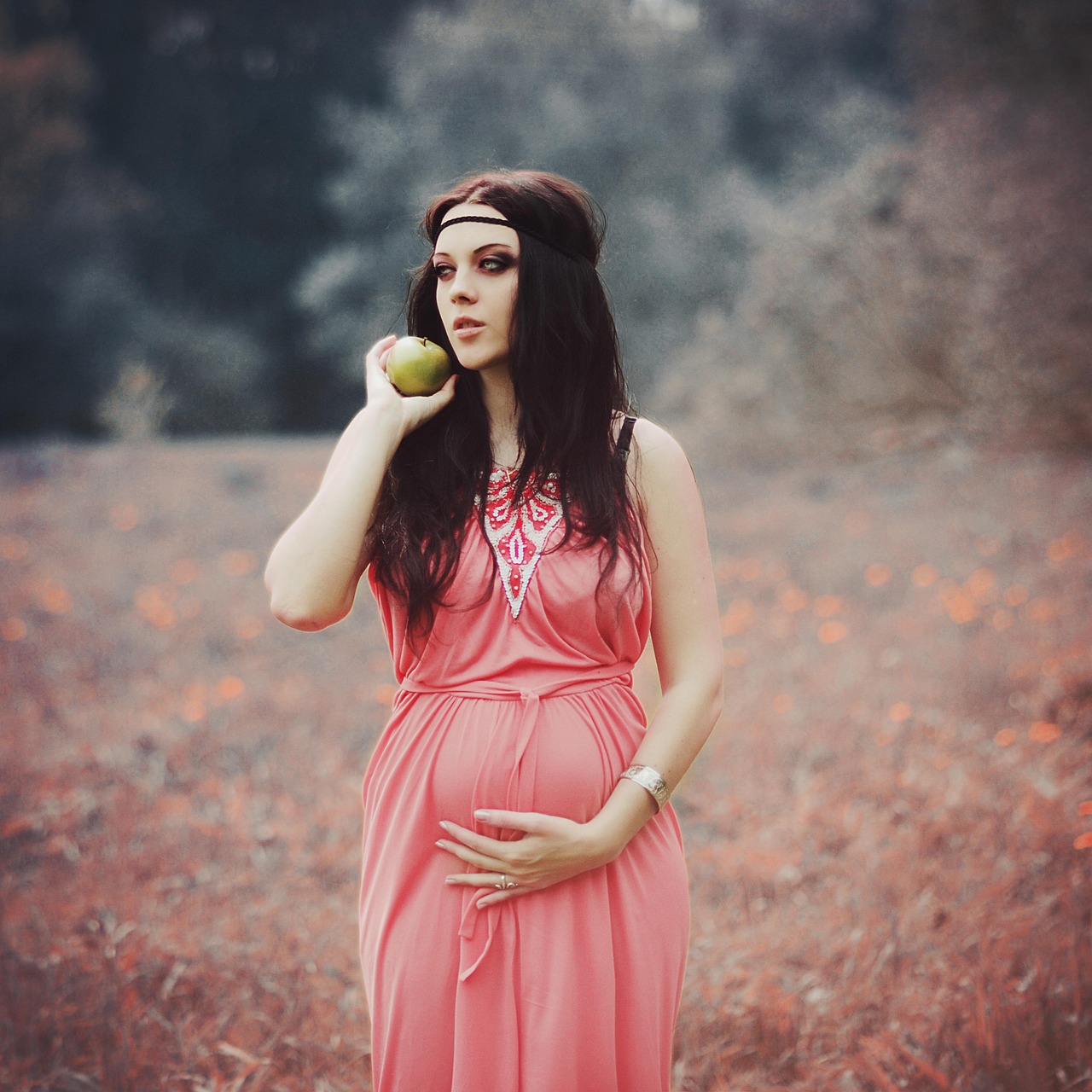 A pregnant woman with lustrous, healthy hair, maintained with pregnancy safe shampoo and conditioner.