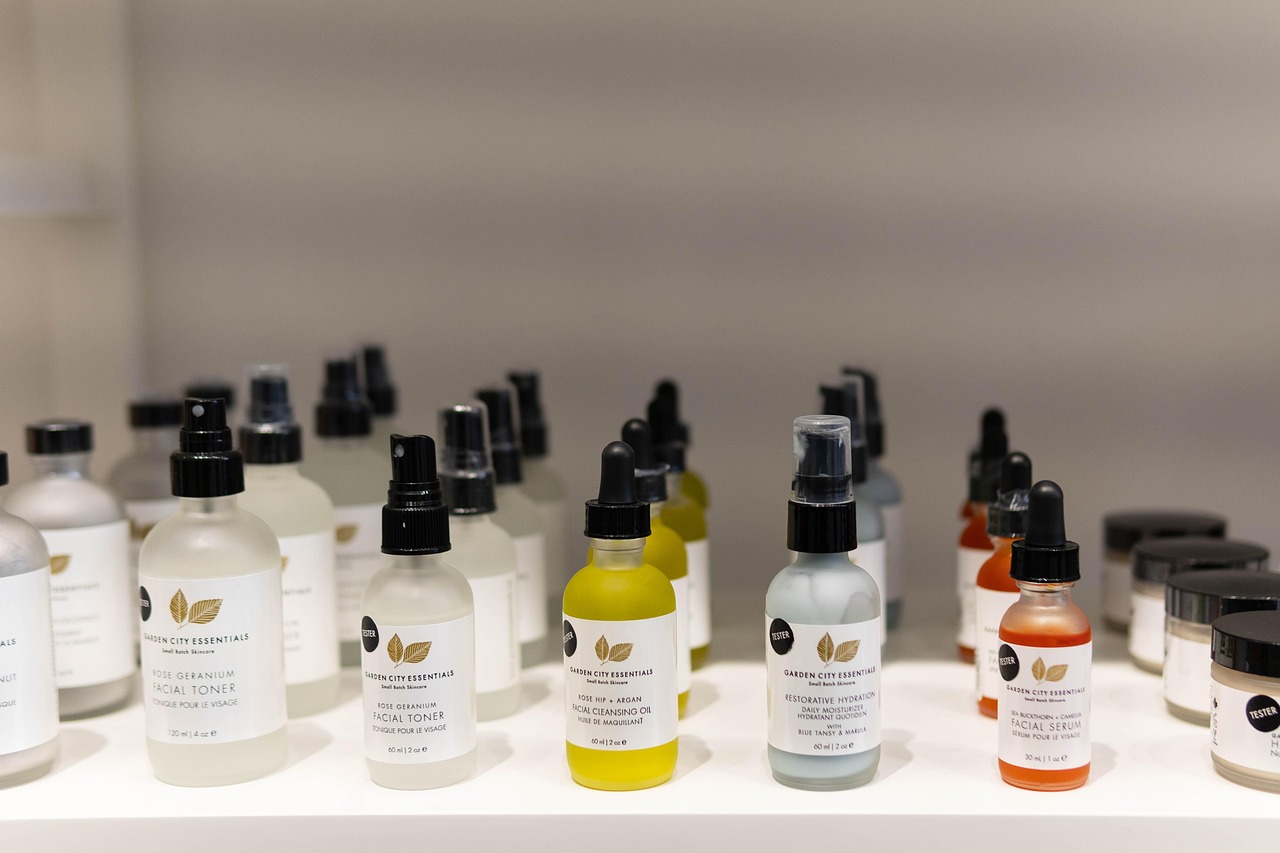 Rows of white skincare serum and cream bottles with pump tops on a shelf, representing pregnancy-safe skincare checks