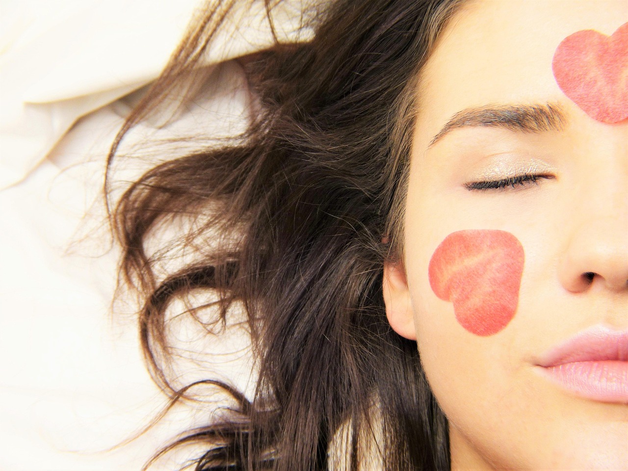 A woman's calm face with clear skin, considering ingredients with a pregnancy safe ingredient checker.