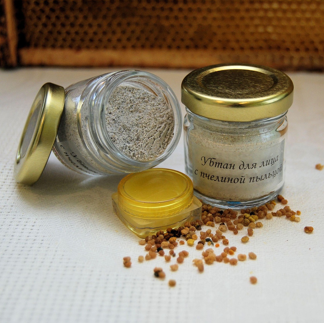 Small glass cosmetic jars of natural balm and powder with grains, representing comparing skincare brands