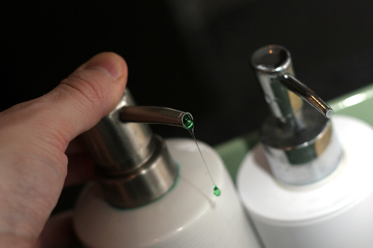 Clear liquid soap or lotion dripping from a bottle, representing skincare products by pregnancy trimester