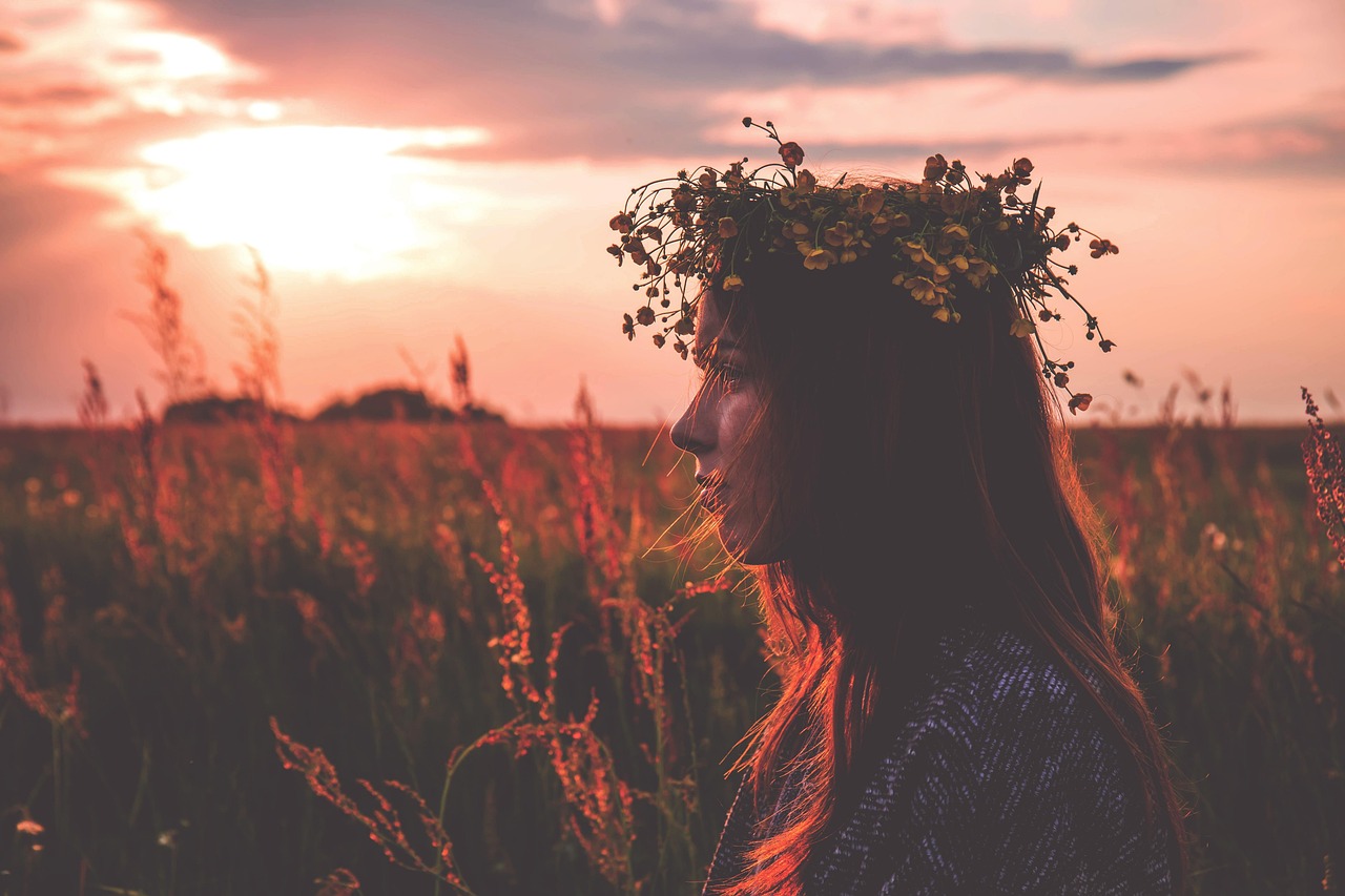 Young woman in a flower crown at sunset, exploring if Lustra is safe during pregnancy.
