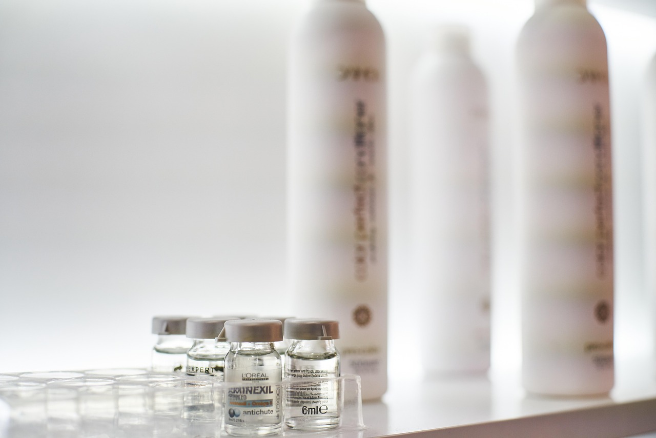 A woman gently applies a niacinamide serum to her face, considering its safety during pregnancy.