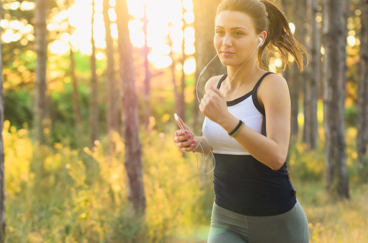 Active woman jogging with earphones, focused on wellness and ascorbic acid safety during pregnancy.