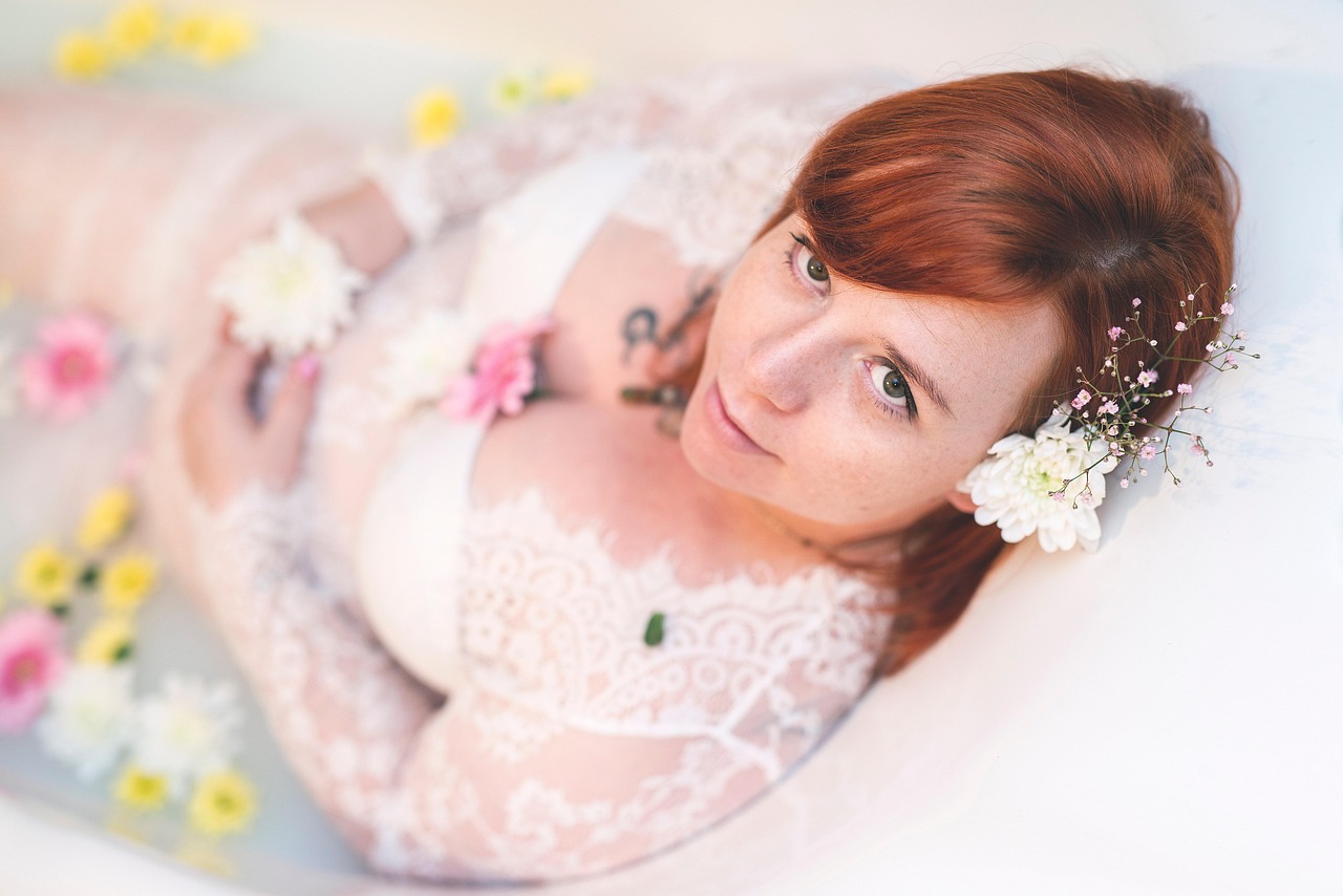 A pregnant woman in a floral setting, for a blog post on Differin Gel safety during pregnancy.