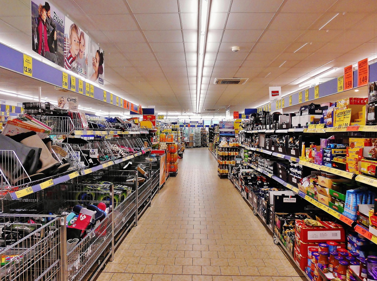 Empty supermarket aisle with shelves of packaged products, representing products a scanner cannot identify yet