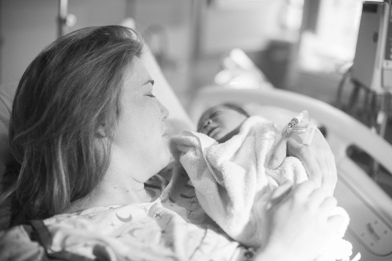 A happy new mother cradles her baby, using SafeMom scanning tips to ensure accurate product information.