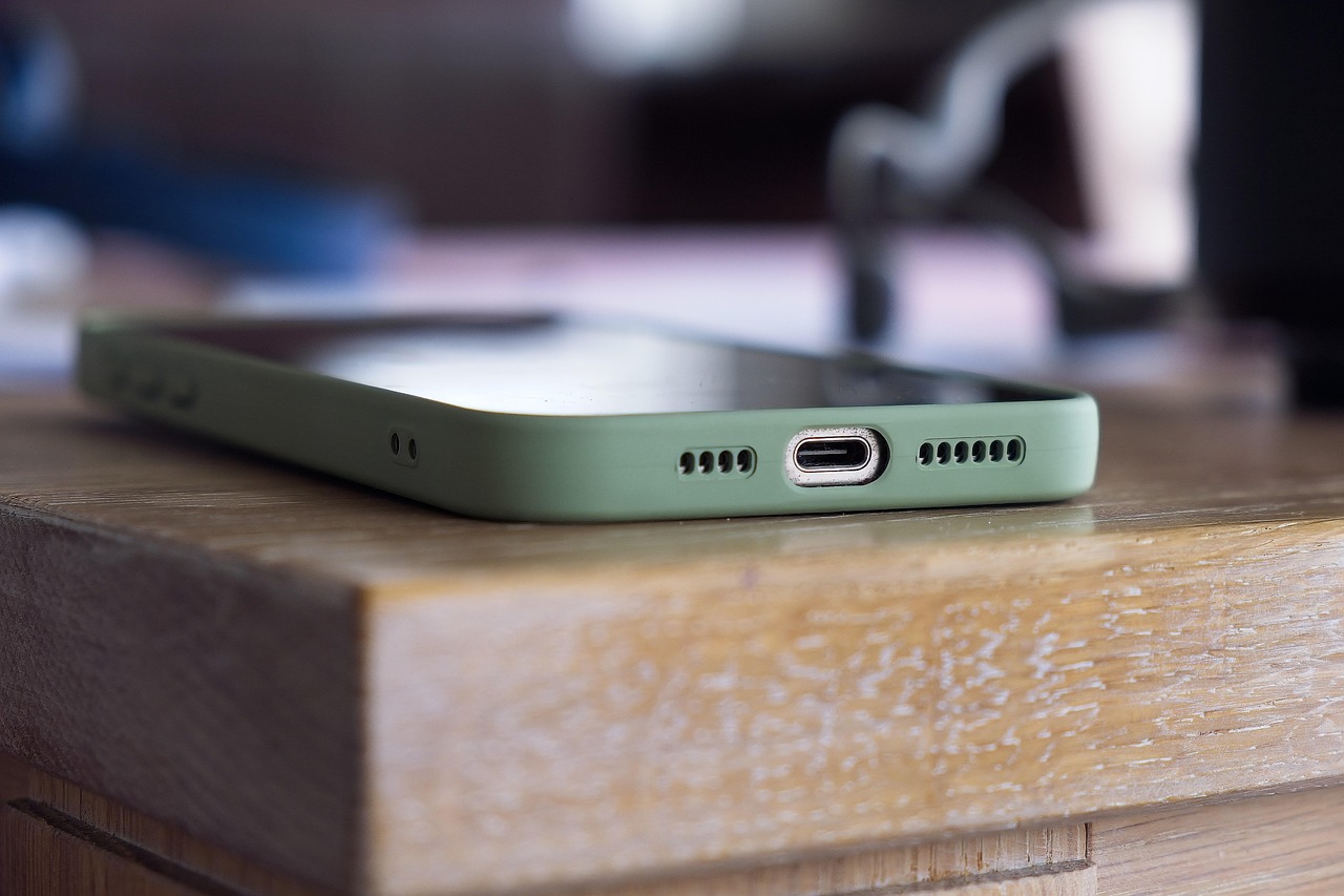 Person holding a green smartphone, representing using an ingredient checker app