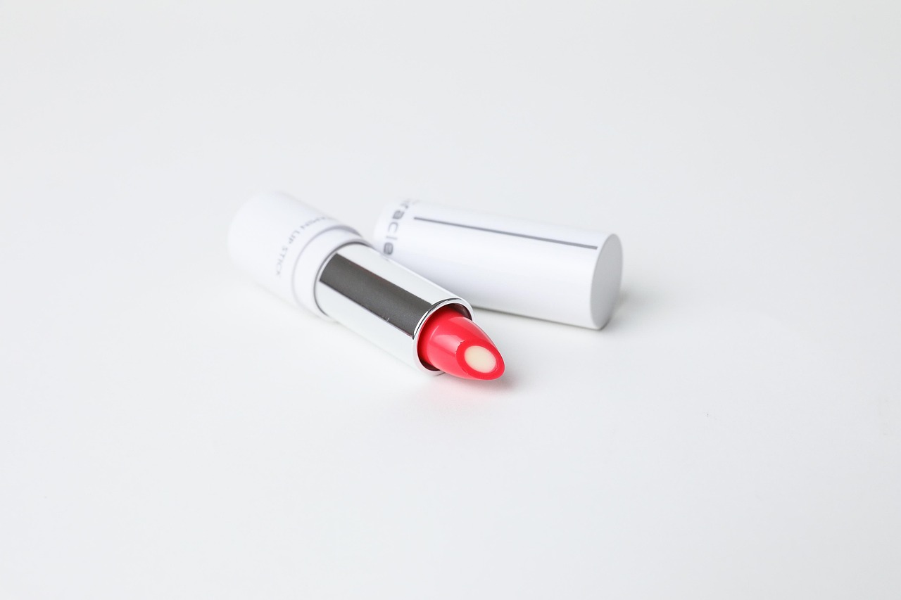 White lipstick tube with pink lipstick on a plain white surface, representing beauty brands moms trust