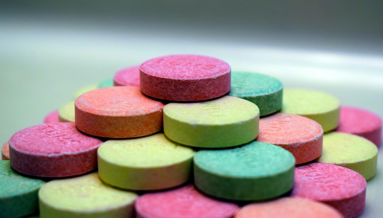 Stack of colorful round chewable antacid tablets, representing Tums for heartburn relief during pregnancy