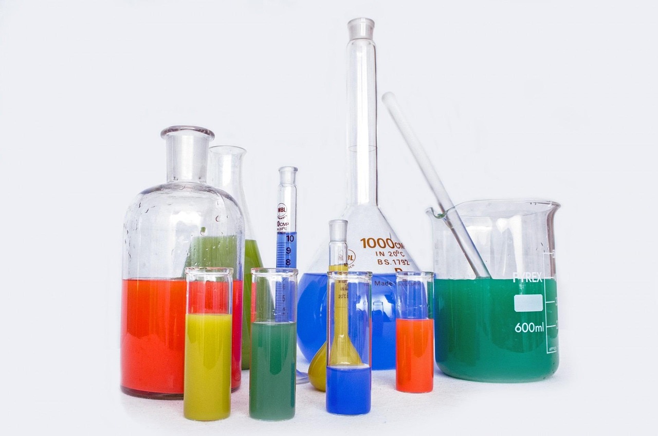 Colorful laboratory beakers and flasks on white, representing ingredient science for expecting parents