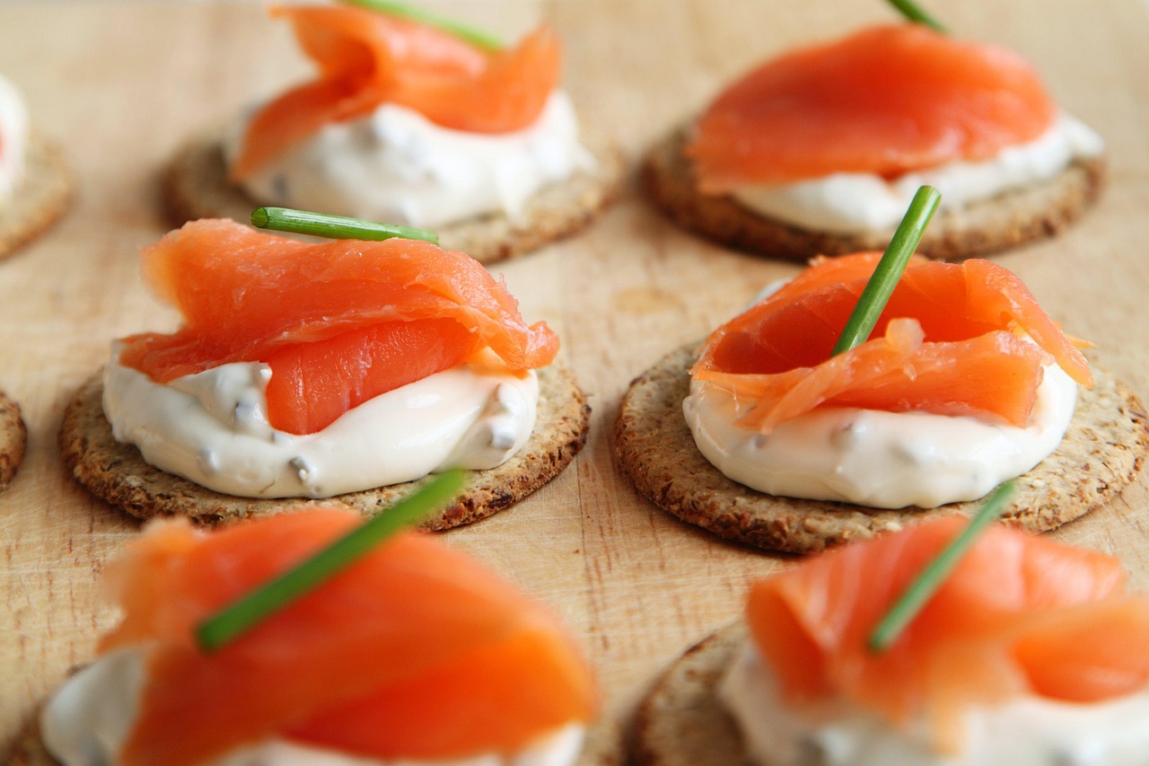 Gourmet smoked salmon canapés on crackers, sparking questions about salmon safety during pregnancy.