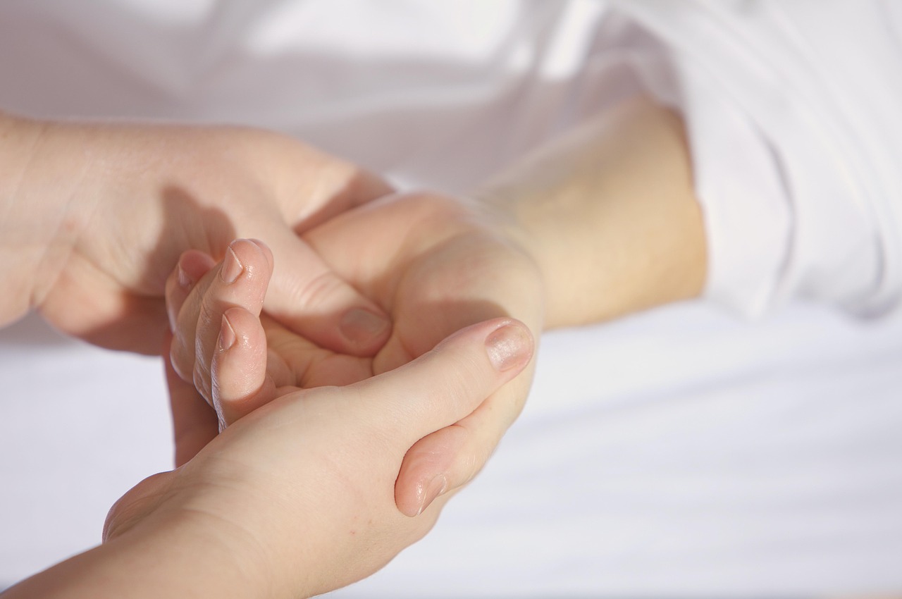 Hands massaging a wrist, detailing aloe barbadensis leaf juice safety for pregnant skin.