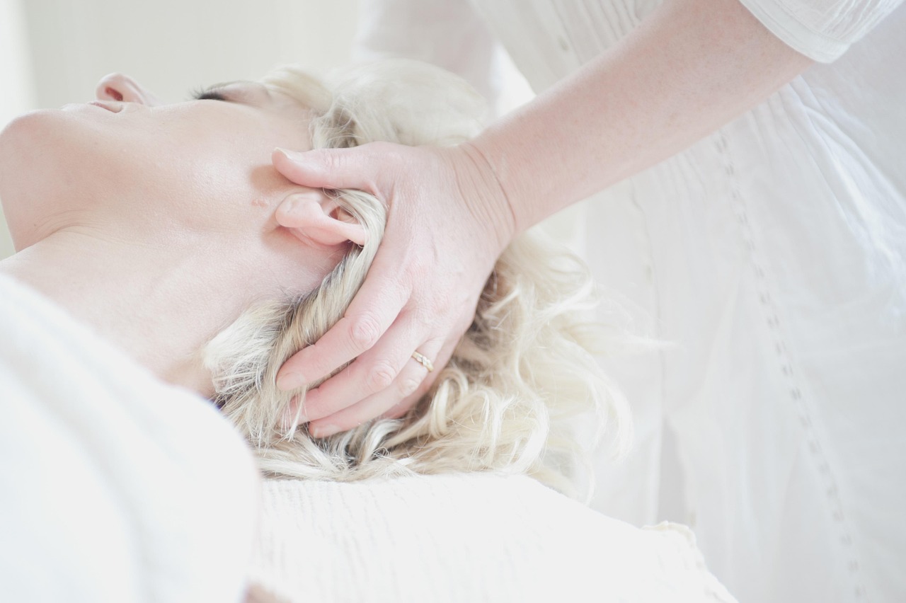 Woman enjoying a head massage, a moment of relaxation for moms researching snail mucin during pregnancy.