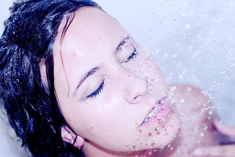 Wet face of a woman showering, reflecting on L'Oreal Sublime Bronze self-tanner safety during pregnancy.
